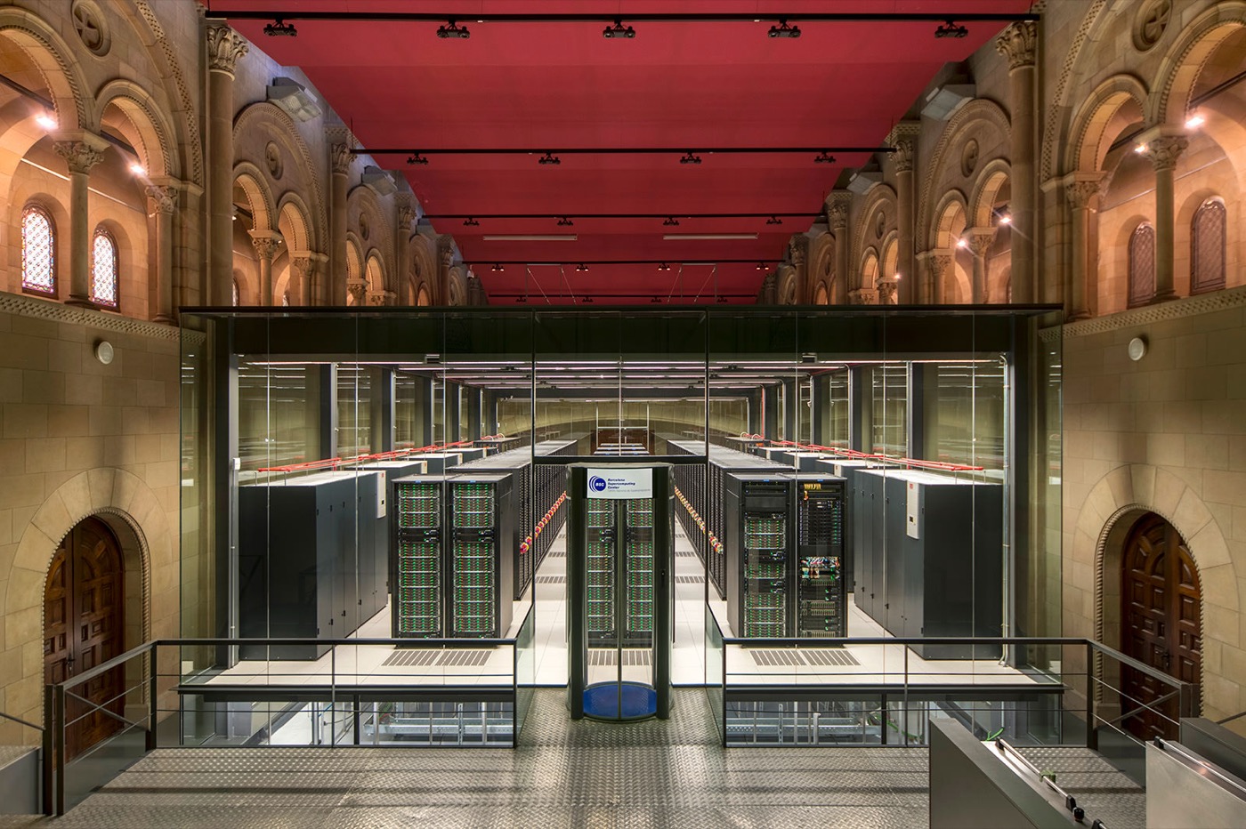 Supercomputer in a glass enclosure inside a historic stone hall