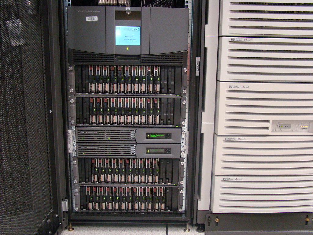 Storage array rack beside a white server cabinet
